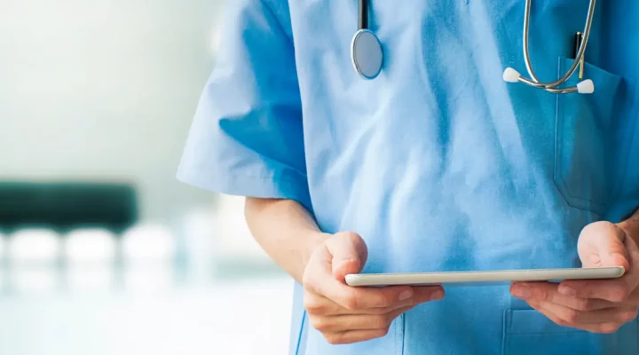 doctor reading notes on clipboard